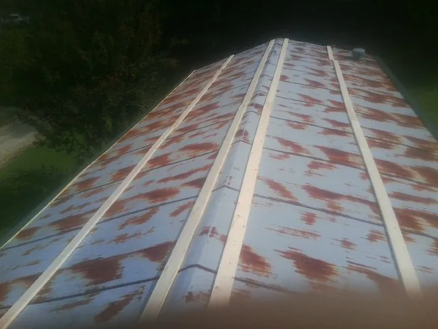 Rusted metal roof panels with new wood purlins before replacement — Storm Damage Roof Repair in Nunica by Roofing Brothers
