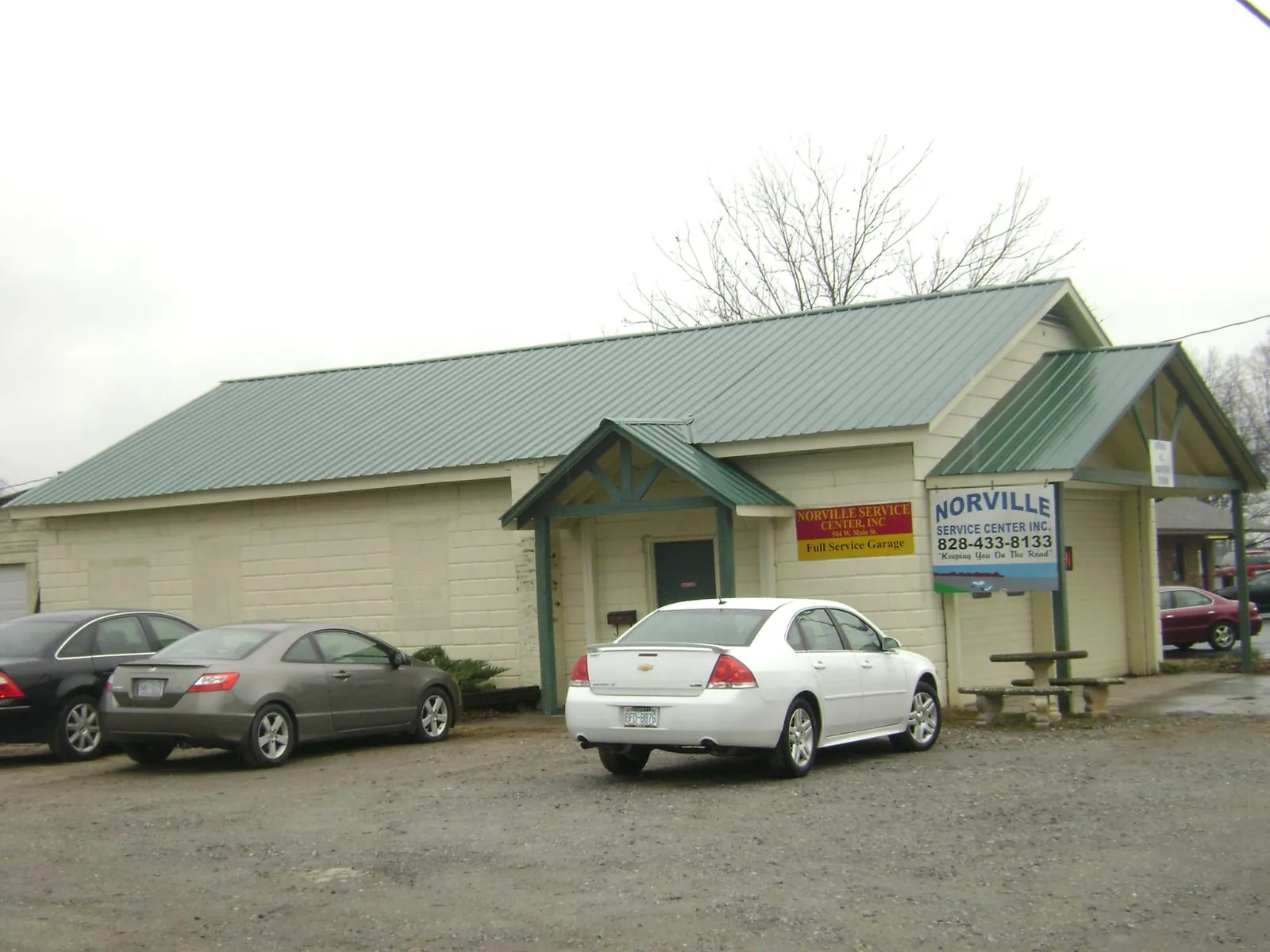 Green metal roof on a service garage with a covered entry in Nunica